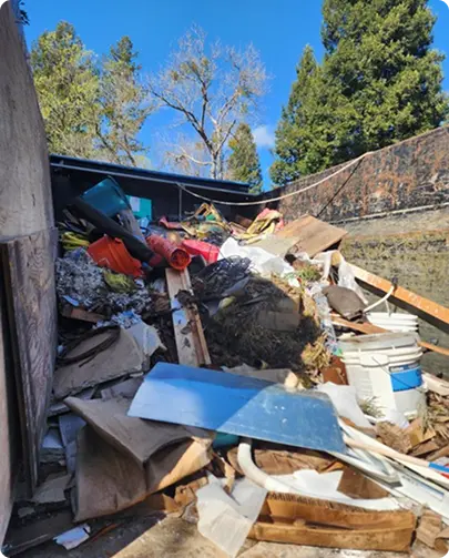 A truck filled with a pile of debris