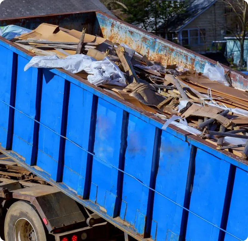 A dump truck filled with wood and debris