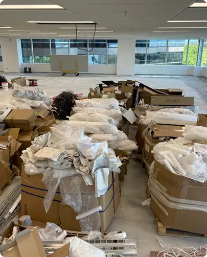 A large room filled with an assortment of boxes and miscellaneous items